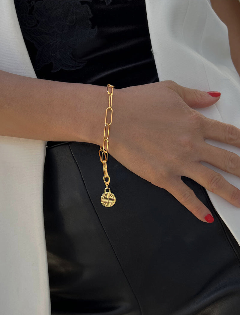 Image Title Female model wearing Asian Inspired Minimalist 2 Way Convertible Lucky Charm Coin Four Blessings Pendant With A Paperclip Link Chain Statement Bold Thick Chunky Layering Stacking Rectangular Bracelet in 18K Gold Vermeil With Sterling Silver base by Sonia Hou, a celebrity AAPI Chinese demi-fine jewelry designer