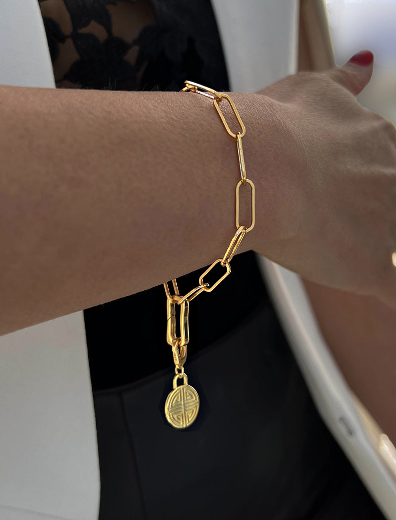 Image Title Female model wearing Asian Inspired Minimalist 2 Way Convertible Lucky Charm Coin Four Blessings Pendant With A Paperclip Link Chain Statement Bold Thick Chunky Layering Stacking Statement Rectangular Bracelet in 18K Gold Vermeil With Sterling Silver base by Sonia Hou, a celebrity AAPI Chinese demi-fine jewelry designer