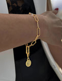 Image Title Female model wearing Asian Inspired Minimalist 2 Way Convertible Lucky Charm Coin Four Blessings Pendant With A Paperclip Link Chain Statement Bold Thick Chunky Layering Stacking Statement Rectangular Bracelet in 18K Gold Vermeil With Sterling Silver base by Sonia Hou, a celebrity AAPI Chinese demi-fine jewelry designer