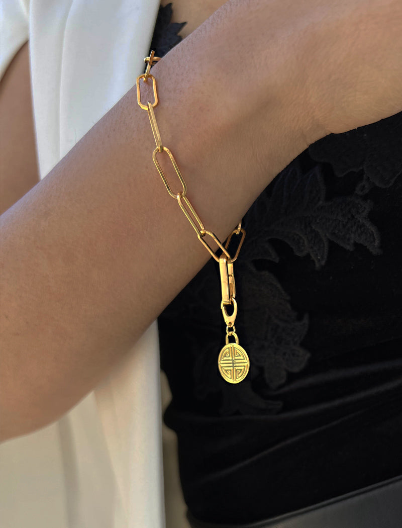 Image Title Female model wearing Asian Inspired Minimalist 2 Way Convertible Lucky Charm Coin Four Blessings Pendant With A Paperclip Link Chain Statement Bold Thick Chunky Layering Stacking Statement Rectangular Bracelet in 18K Gold Vermeil With Sterling Silver base by Sonia Hou, a celebrity AAPI Chinese demi-fine jewelry designer
