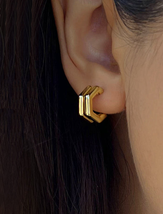 Female model wearing minimalist small chunky bold thick dainty stacking layering statement round FUTURISTIC Double Hexagon Huggie Hoop Earrings in 18K Gold Vermeil With 925 Sterling Silver base by Sonia Hou, a celebrity AAPI Chinese demi-fine jewelry designer