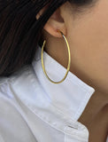 Female model wearing big medium large thin round circle PERFECT 50mm 2 inch hoop stacking lightweight everyday statement earrings in 18K Gold Vermeil With 925 Sterling Silver base by Sonia Hou, a celebrity AAPI Chinese demi-fine jewelry designer