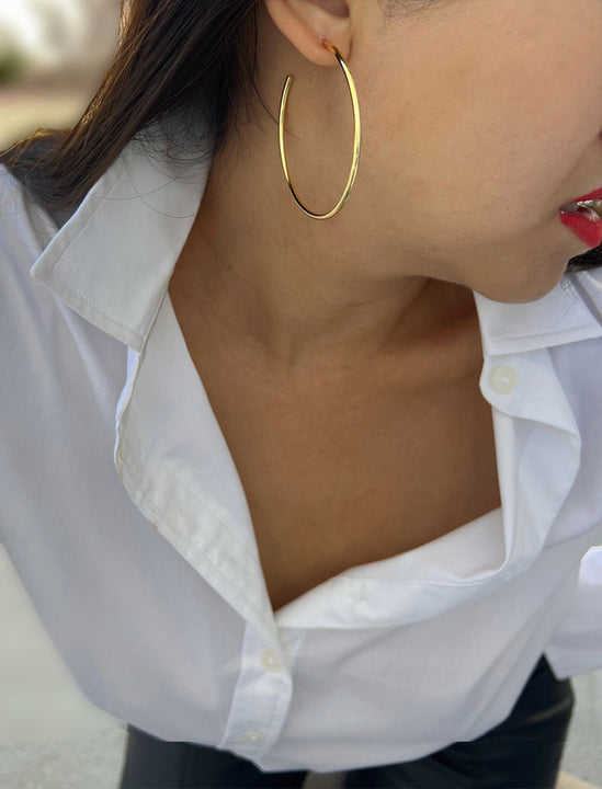 Female model wearing big medium large thin round circle PERFECT 50mm or 2 inch hoop stacking lightweight everyday statement earrings in 18K Gold Vermeil With 925 Sterling Silver base by Sonia Hou, a celebrity AAPI Chinese demi-fine jewelry designer