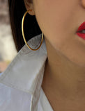 Female model wearing big medium large thin round circle PERFECT 50mm or 2 inch hoop stacking lightweight everyday statement earrings in 18K gold vermeil with a 925 Sterling Silver base by Sonia Hou, a celebrity AAPI Chinese demi-fine jewelry designer