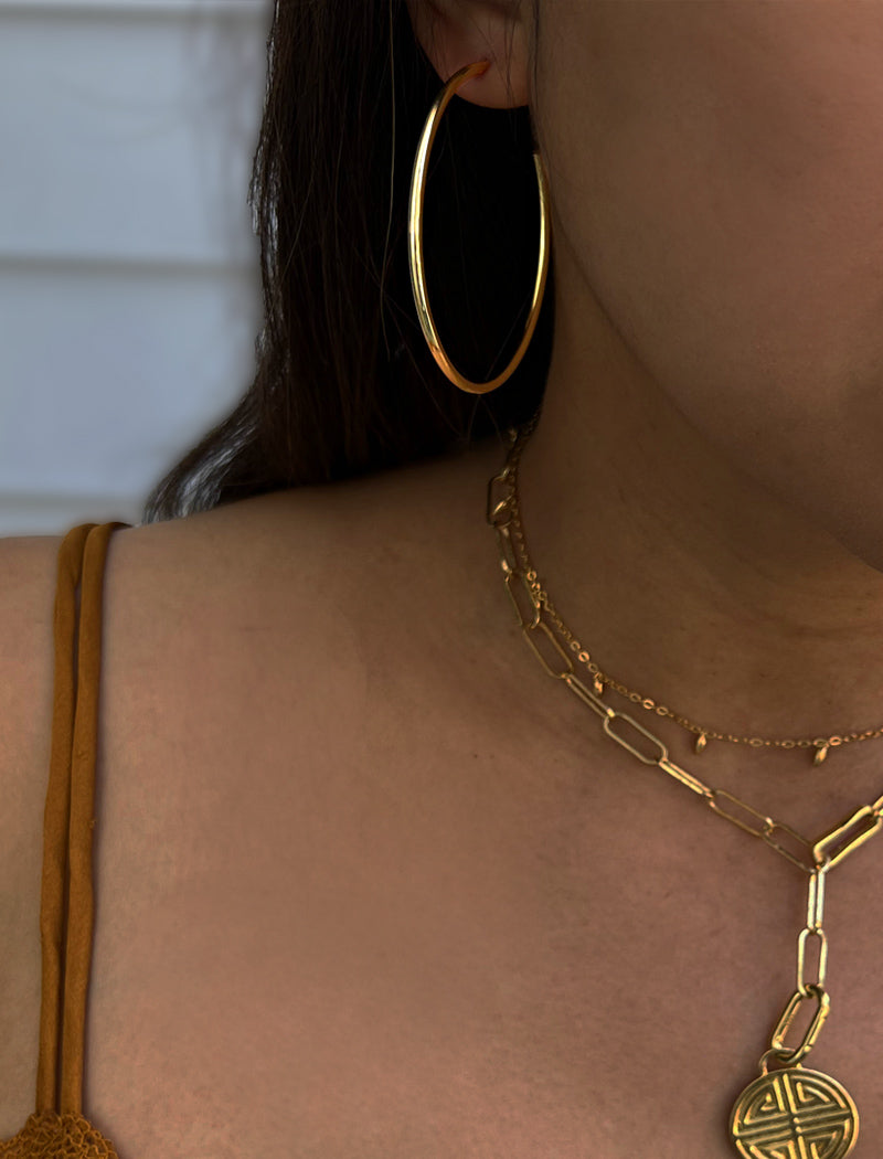 Image Title Female model wearing big medium large thin round circle PERFECT 50mm 2 inch hoop stacking lightweight everyday statement earrings in 18K Gold Vermeil With 925 Sterling Silver base by Sonia Hou, a celebrity AAPI Chinese demi-fine jewelry designer