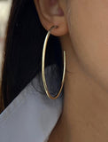 Female model wearing big medium large thin round circle PERFECT 50mm 2 inch hoop stacking lightweight everyday statement earrings in 925 Sterling Silver by Sonia Hou, a celebrity AAPI Chinese demi-fine jewelry designer