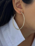 Female model wearing big medium large thin round circle PERFECT 50mm or 2 inch hoop stacking lightweight everyday statement earrings in 925 Sterling Silver by Sonia Hou, a celebrity AAPI Chinese demi-fine jewelry designer