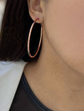 Female model wearing big medium large thin round circle PERFECT 50mm 2 inch hoop stacking lightweight everyday statement earrings in 18K Rose Gold Vermeil With 925 Sterling Silver base by Sonia Hou, a celebrity AAPI Chinese demi-fine jewelry designer