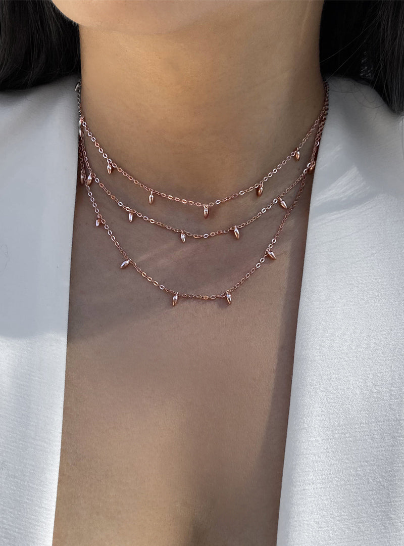 Image Title Female model wearing inclusive Asian inspired thin Rice bead minimalist chain layering stacking necklace in 18K rose gold vermeil with sterling silver base by Sonia Hou, a celebrity Chinese AAPI demi-fine jewelry designer