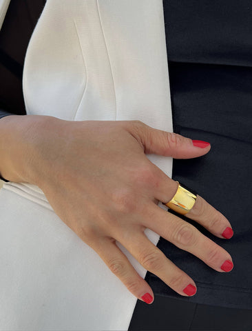 Image Title Female model wearing wide RICH thick bold chunky statement cigar band ring in 18K gold vermeil with a 925 sterling silver base by Sonia Hou, a celebrity AAPI Chinese demi-fine jewelry designer