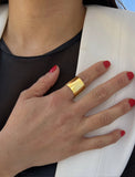 Female model wearing wide RICH thick bold chunky statement cigar band ring in 18K gold vermeil with a 925 sterling silver base by Sonia Hou, a celebrity AAPI Chinese demi-fine jewelry designer