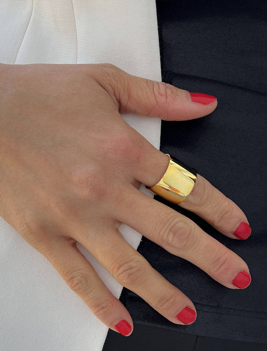 Female model wearing wide RICH thick bold chunky statement cigar band ring in 18k gold vermeil with 925 sterling silver base by Sonia Hou, a celebrity AAPI Chinese demi-fine jewelry designer