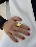 Female model wearing wide RICH thick bold chunky statement cigar band ring in 18k gold vermeil with 925 sterling silver base by Sonia Hou, a celebrity AAPI Chinese demi-fine jewelry designer