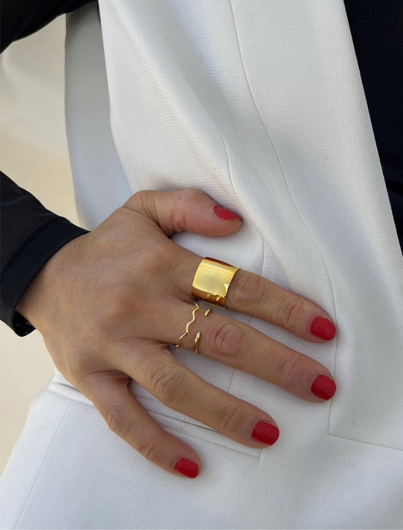 Image Title Female model wearing wide RICH thick bold chunky statement cigar band ring in 18K gold vermeil with a 925 sterling silver base by Sonia Hou, a celebrity AAPI Chinese demi-fine jewelry designer