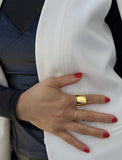 Female model wearing wide RICH thick bold chunky statement cigar band ring in 18k gold vermeil with 925 sterling silver base by Sonia Hou, a celebrity AAPI Chinese demi-fine jewelry designer