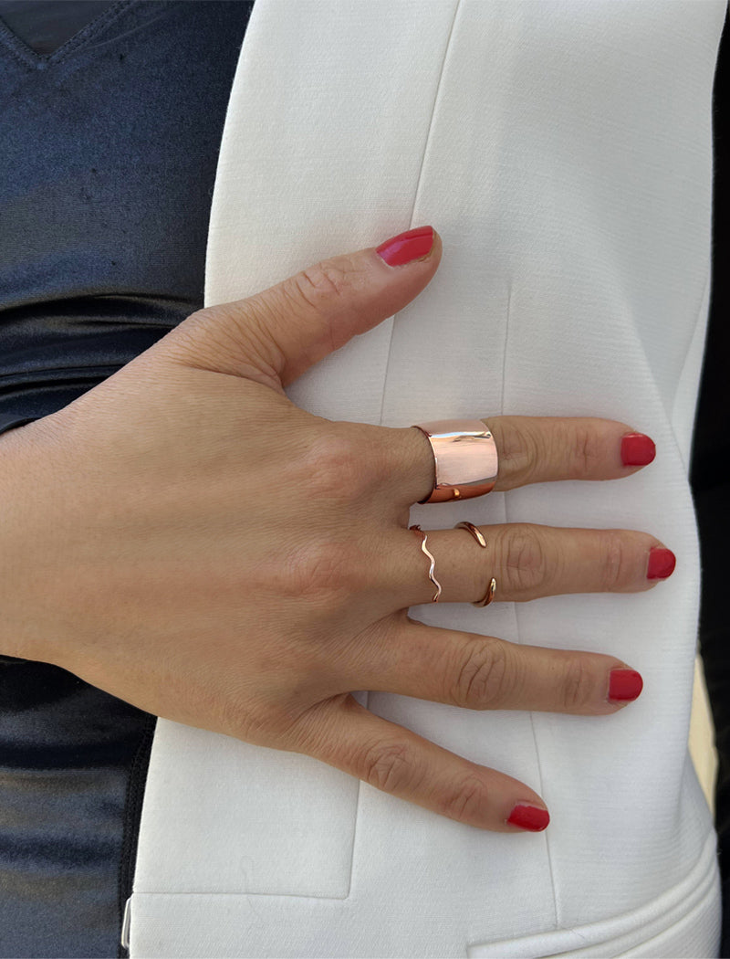 Image Title Female model wearing wide RICH thick bold chunky statement cigar band ring in 18K rose gold vermeil with a 925 sterling silver base by Sonia Hou, a celebrity AAPI Chinese demi-fine jewelry designer