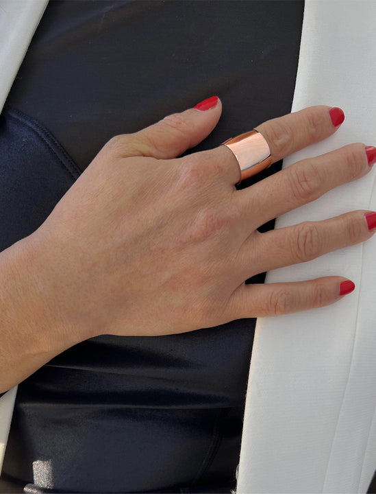 Female model wearing RICH wide thick bold chunky statement cigar band ring in 18K rose gold vermeil with a 925 sterling silver base by Sonia Hou, a celebrity AAPI Chinese demi-fine jewelry designer