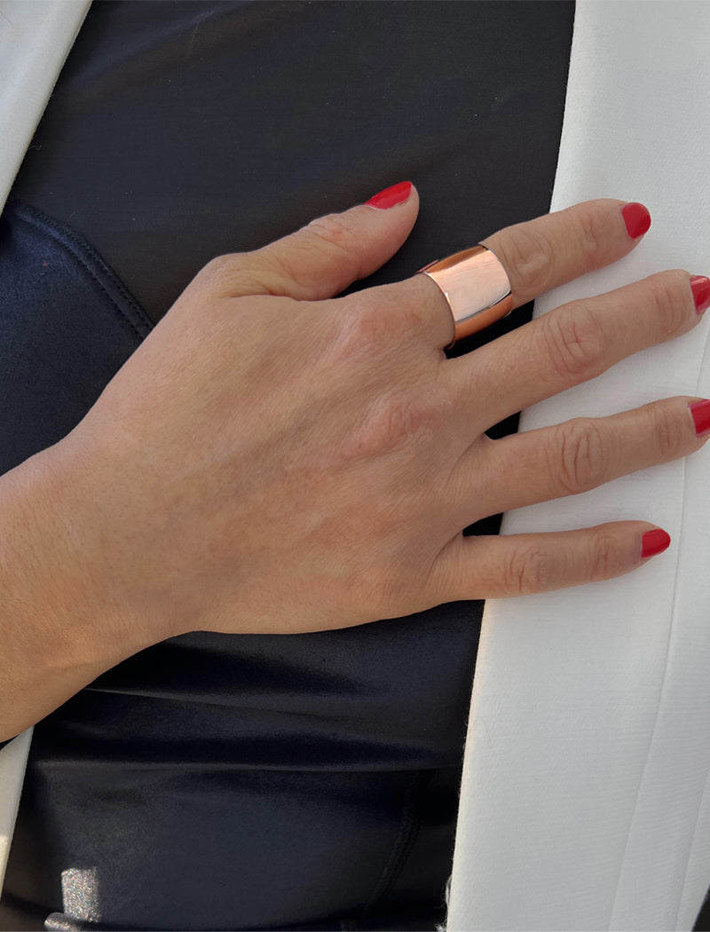 Image Title Female model wearing wide RICH thick bold chunky statement cigar band ring in 18K rose gold vermeil with a 925 sterling silver base by Sonia Hou, a celebrity AAPI Chinese demi-fine jewelry designer
