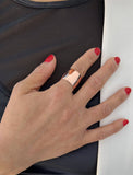 Female model wearing wide RICH thick bold chunky statement cigar band ring in 18K rose gold vermeil with a 925 sterling silver base by Sonia Hou, a celebrity AAPI Chinese demi-fine jewelry designer