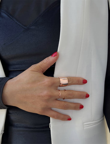 Image Title Female model wearing wide RICH thick bold chunky statement cigar band ring in 18K rose gold vermeil with a 925 sterling silver base by Sonia Hou, a celebrity AAPI Chinese demi-fine jewelry designer