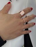 Female model wearing wide RICH thick bold chunky statement cigar band ring in 18k rose gold vermeil with 925 sterling silver base by Sonia Hou, a celebrity AAPI Chinese demi-fine jewelry designer