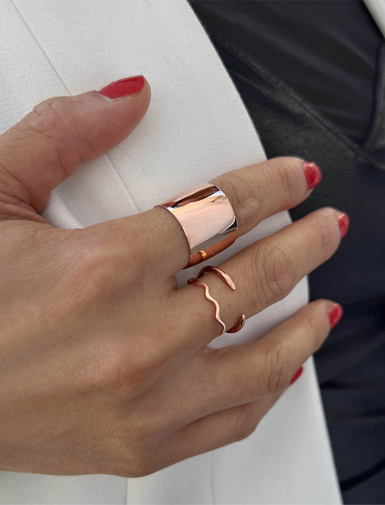 Female model wearing wide  RICH thick bold chunky statement cigar band ring in 18k rose gold vermeil with 925 sterling silver base by Sonia Hou, a celebrity AAPI Chinese demi-fine jewelry designer