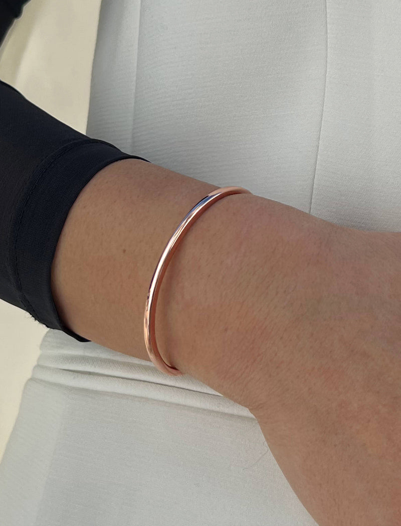 Image Title Female model wearing adjustable minimalist simple Success Thin Cuff Chunky Bold Layering Stacking Statement 2 Way convertible Bangle Cuff Open Bracelet in 18K Rose Gold Vermeil with 925 sterling silver base by Sonia Hou, a celebrity AAPI Chinese demi-fine fashion costume jewelry designer