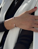 Image Title Female model wearing adjustable minimalist simple Success Thin Cuff Chunky Bold Layering Stacking Statement 2 Way convertible Bangle Cuff Open Bracelet in 925 sterling silver by Sonia Hou, a celebrity AAPI Chinese demi-fine fashion costume jewelry designer
