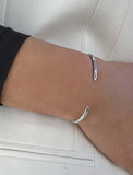 Female model wearing adjustable minimalist simple Success Thin Cuff Chunky Bold Layering Stacking Statement 2 Way convertible Bangle Cuff Open Bracelet in 925 sterling silver by Sonia Hou, a celebrity AAPI Chinese demi-fine fashion costume jewelry designer