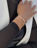 Female model wearing adjustable minimalist simple Success Thin Cuff Chunky Bold Layering Stacking Statement 2 Way convertible Bangle Cuff Open Bracelet in 925 sterling silver by Sonia Hou, a celebrity AAPI Chinese demi-fine fashion costume jewelry designer