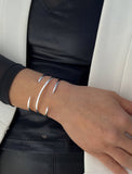 Female model wearing adjustable minimalist simple Success Thin Cuff Chunky Bold Layering Stacking Statement 2 Way convertible Bangle Cuff Open Bracelet in 925 sterling silver by Sonia Hou, a celebrity AAPI Chinese demi-fine fashion costume jewelry designer