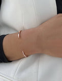 Image Title Female model wearing adjustable minimalist simple Success Thin Cuff Chunky Bold Layering Stacking Statement 2 Way convertible Bangle Cuff Open Bracelet in 18K Rose Gold Vermeil with 925 sterling silver base by Sonia Hou, a celebrity AAPI Chinese demi-fine fashion costume jewelry designer