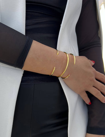 Image Title Female model wearing adjustable minimalist simple Success Thin Cuff Chunky Bold Layering Stacking Statement 2 Way convertible Bangle Cuff Open Bracelet in 18K Gold Vermeil with 925 sterling silver base by Sonia Hou, a celebrity AAPI Chinese demi-fine fashion costume jewelry designer