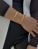 Image Title Female model wearing adjustable minimalist simple Success Thin Cuff Chunky Bold Layering Stacking Statement 2 Way convertible Bangle Cuff Open Bracelet in 18K Gold Vermeil with 925 sterling silver base by Sonia Hou, a celebrity AAPI Chinese demi-fine fashion costume jewelry designer