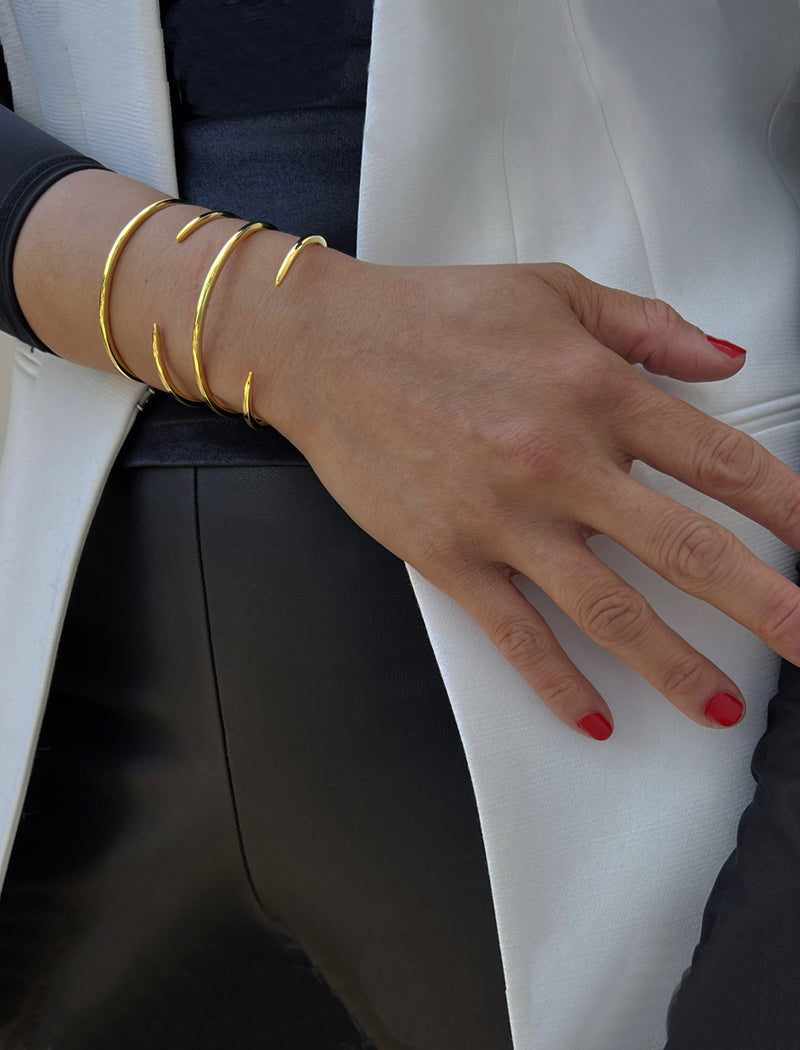 Image Title Female model wearing adjustable minimalist simple Success Thin Cuff Chunky Bold Layering Stacking Statement 2 Way convertible Bangle Cuff Open Bracelet in 18K Gold Vermeil with 925 sterling silver base by Sonia Hou, a celebrity AAPI Chinese demi-fine fashion costume jewelry designer
