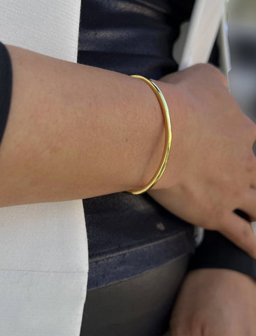 Image Title Female model wearing adjustable minimalist simple Success Thin Cuff Chunky Bold Layering Stacking Statement 2 Way convertible Bangle Cuff Open Bracelet in 18K Gold Vermeil with 925 sterling silver base by Sonia Hou, a celebrity AAPI Chinese demi-fine fashion costume jewelry designer