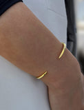 Image Title Female model wearing adjustable minimalist simple Success Thin Cuff Chunky Bold Layering Stacking Statement 2 Way convertible Bangle Cuff Open Bracelet in 18K Gold Vermeil with 925 sterling silver base by Sonia Hou, a celebrity AAPI Chinese demi-fine fashion costume jewelry designer