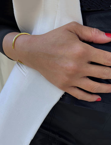 Image Title Female model wearing adjustable minimalist simple Success Thin Cuff Chunky Bold Layering Stacking Statement 2 Way convertible Bangle Cuff Open Bracelet in 18K Gold Vermeil with 925 sterling silver base by Sonia Hou, a celebrity AAPI Chinese demi-fine fashion costume jewelry designer