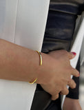 Image Title Female model wearing adjustable minimalist simple Success Thin Cuff Chunky Bold Layering Stacking Statement 2 Way convertible Bangle Cuff Open Bracelet in 18K Gold Vermeil with 925 sterling silver base by Sonia Hou, a celebrity AAPI Chinese demi-fine fashion costume jewelry designer