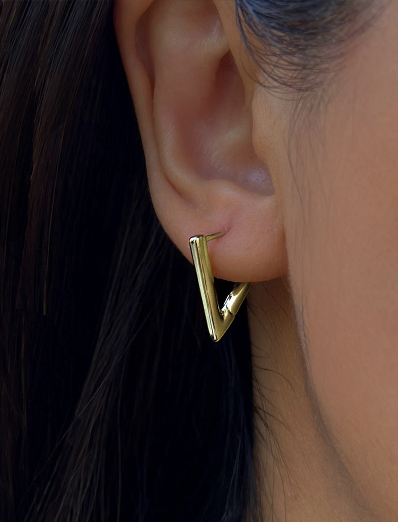 Female Model wearing ACHIEVE TRIANGLE GEOMETRIC HUGGIE EARRINGS in Sterling Silver by Sonia Hou Jewelry