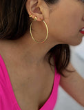 Female model with an ear stack, wearing big medium large thin round circle PERFECT 50mm or 2 inch hoop stacking lightweight everyday statement earrings in 18K gold vermeil with a 925 Sterling Silver base by Sonia Hou, a celebrity AAPI Chinese demi-fine jewelry designer