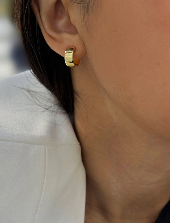 Female model wearing minimalist dainty small thick bold everyday BOSS 18K Gold Vermeil 925 Sterling Silver Chubby Mini Huggie Hoop Earrings by Sonia Hou, a celebrity Chinese AAPI demi-fine fashion costume jewelry designer