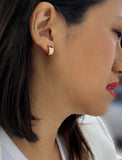 Female model wearing BOSS 18K ROSE GOLD VERMEIL OVER STERLING SILVER MINIMALIST CHUBBY MINI SMALL ROUND HOOP EARRINGS by Sonia Hou Jewelry