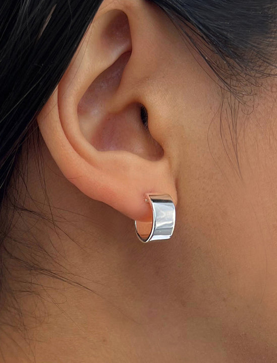 Female model wearing minimalist dainty small thick bold everyday BOSS 925 Sterling Silver Chubby Mini Huggie Hoop Earrings by Sonia Hou, a celebrity Chinese AAPI demi-fine fashion costume jewelry designer