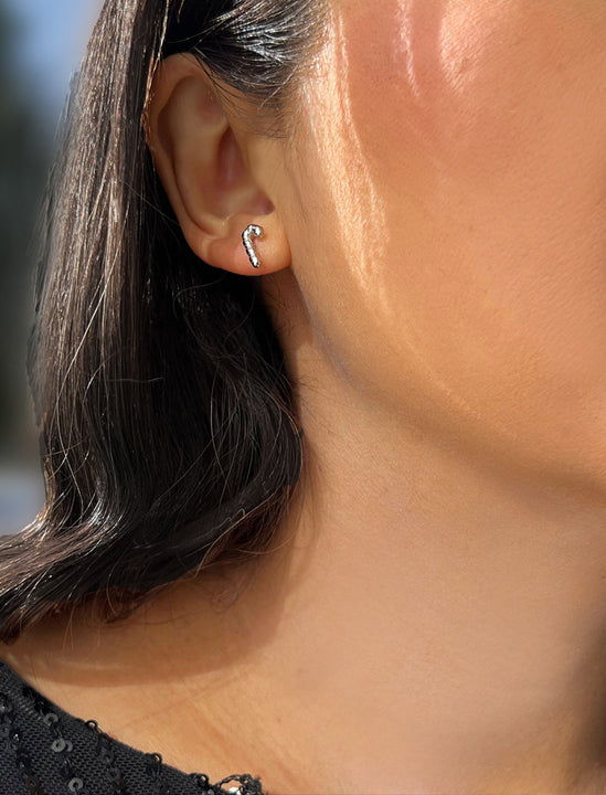 Female model wearing Candy Cane Holiday Festive Christmas Earrings in Sterling Silver by AAPI Celebrity Jewelry Designer Sonia Hou 