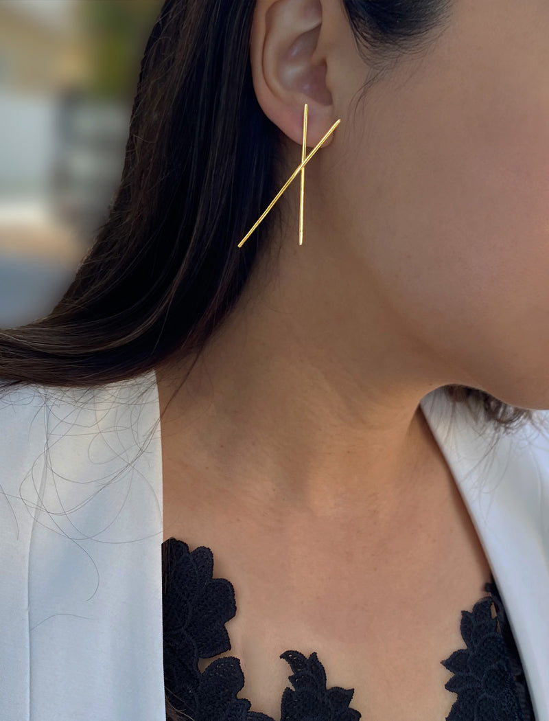 Female Model wearing Asian Inspired Chopsticks Minimalist Long Thin Dangle Earrings in 18K Gold Vermeil With Sterling Silver base by Sonia Hou, a celebrity AAPI demi-fine jewelry designer. 