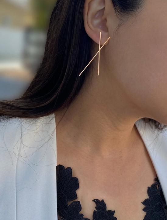 Female Model wearing Asian Inspired Chopsticks Minimalist Long Thin Dangle Earrings in 18K Rose Gold Vermeil With Sterling Silver base by Sonia Hou, a celebrity AAPI demi-fine jewelry designer. 