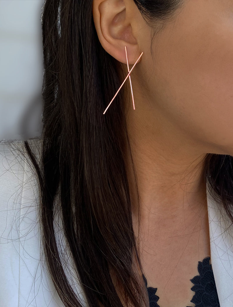 Female Model wearing Asian Inspired Chopsticks Minimalist Long Thin Dangle Earrings in 18K Rose Gold Vermeil With Sterling Silver base by Sonia Hou, a celebrity AAPI demi-fine jewelry designer. 