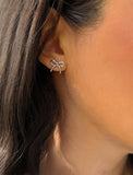 Female model wearing Holiday Coquette Bow Festive Christmas Stud Earrings in Sterling Silver by AAPI Celebrity Jewelry Designer Sonia Hou 
