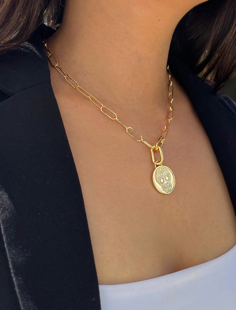 Female model wearing gender neutral, culturally inclusive Day Of The Dead Mexican Sugar Skull Charm 3-Way Convertible Coin Pendant with a Large Paperclip Link Chain Statement Bold Thick Chunky Layering Stacking Rectangular Necklace in 18K Gold Vermeil Over Sterling Silver by Sonia Hou, a celebrity AAPI Chinese demi-fine jewelry designer. This holiday is also known as Dia De Los Muertos, and can also be worn for Halloween!